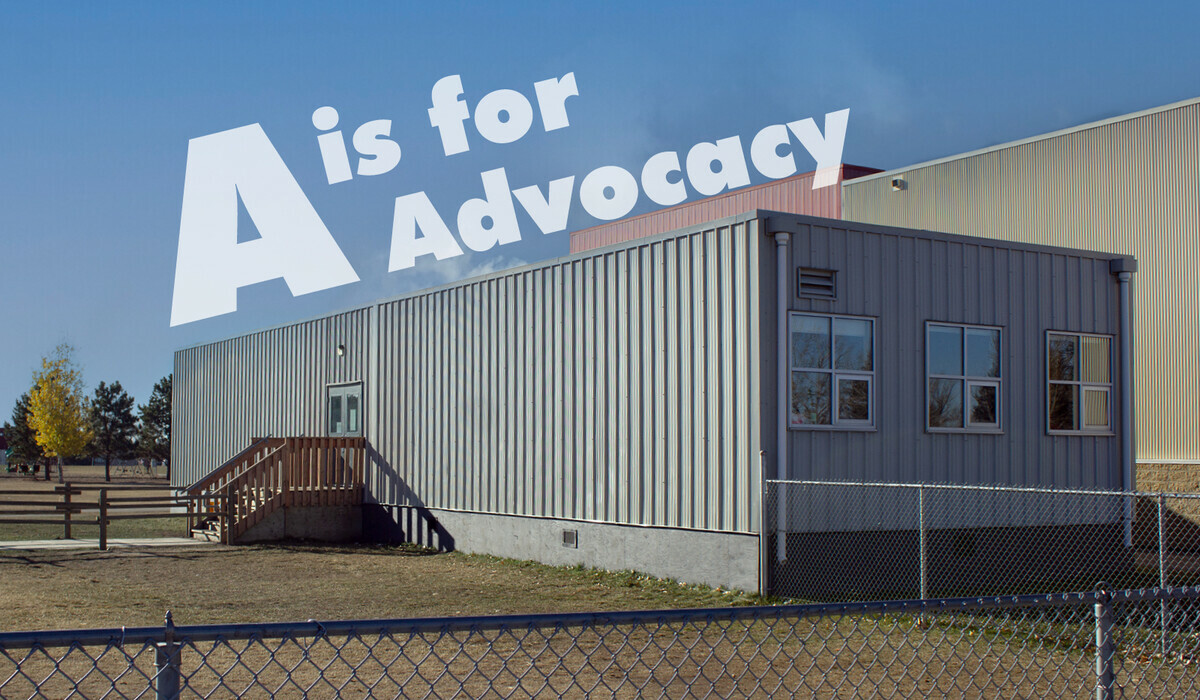 Image of the outside of a modular classroom. The text A is for Advocacy is placed over the image.