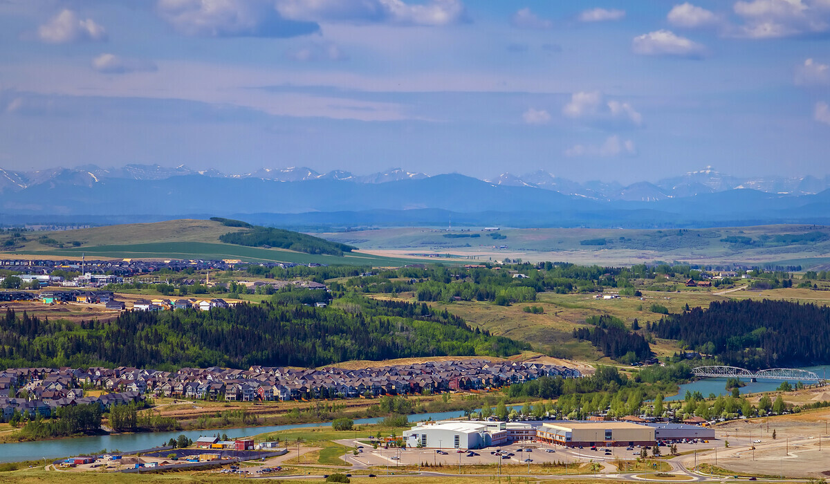 Aerial view of the Town of Cochrane looking towards the mountains.