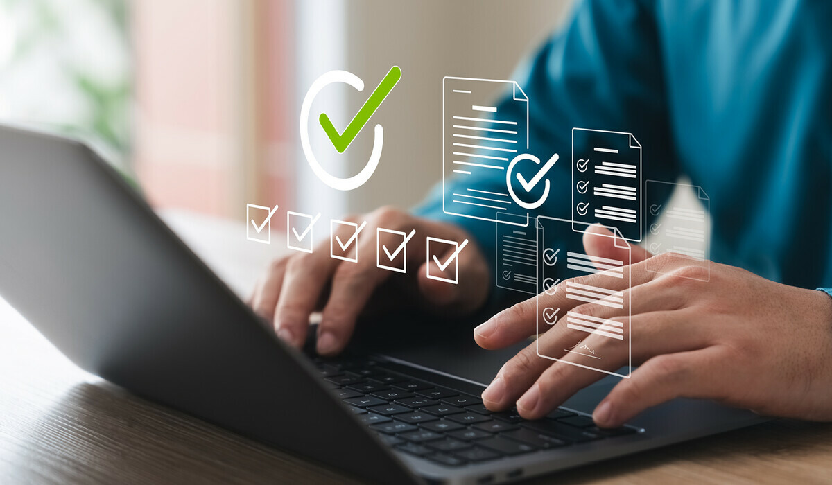 A person types on a laptop with digital survey icons and checkmarks overlaid.